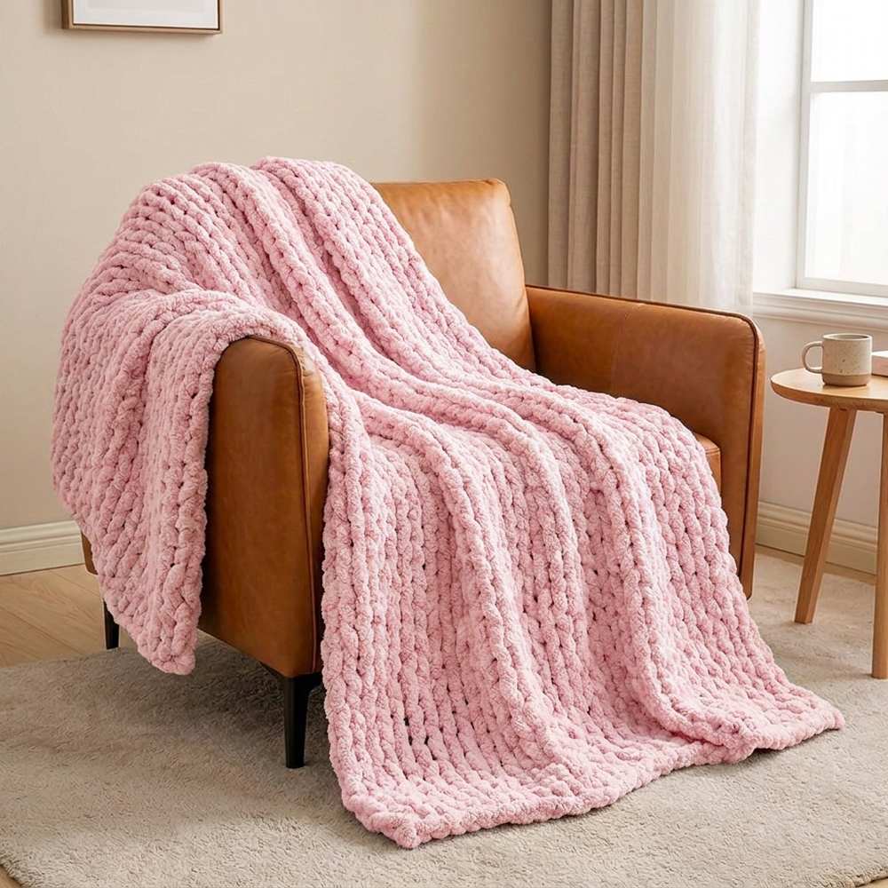 Plaid grosse maille rose clair sur fauteuil